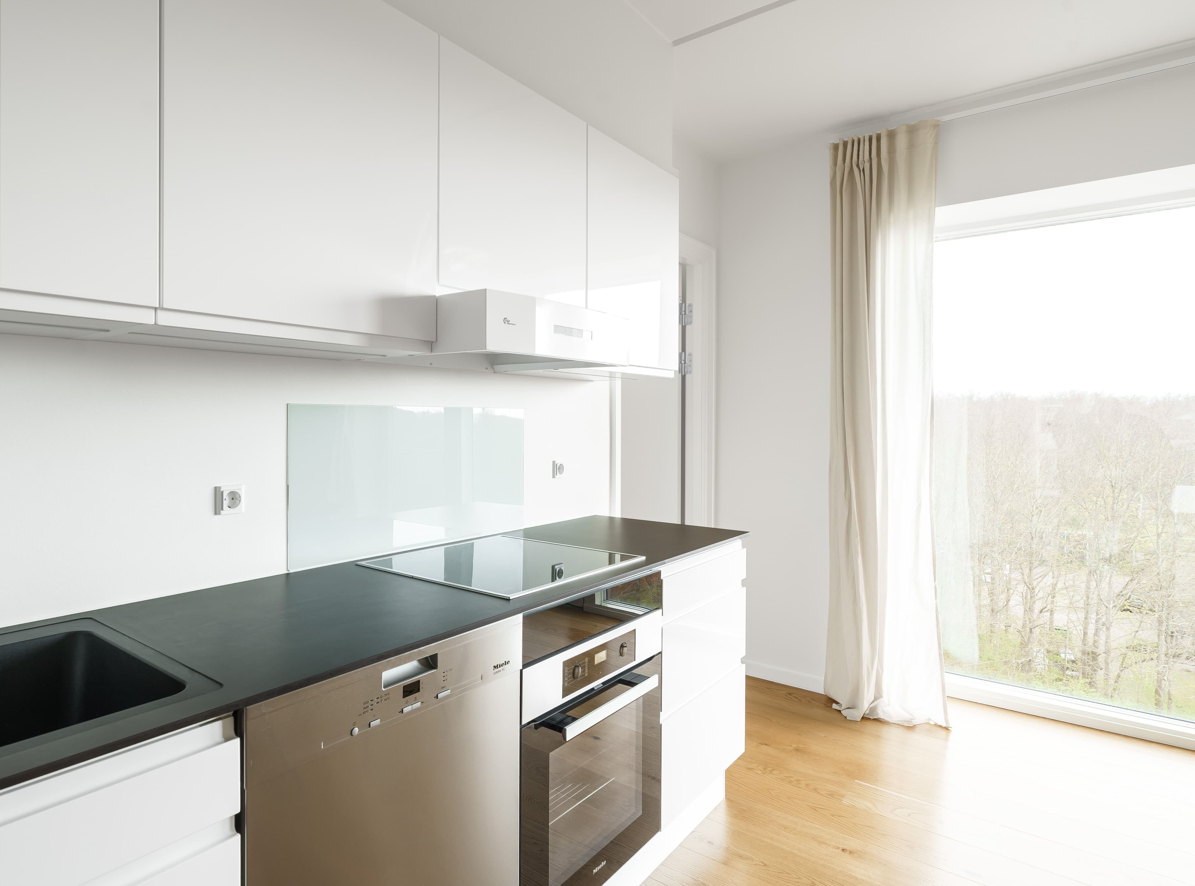 A kitchen with a black marble countertop