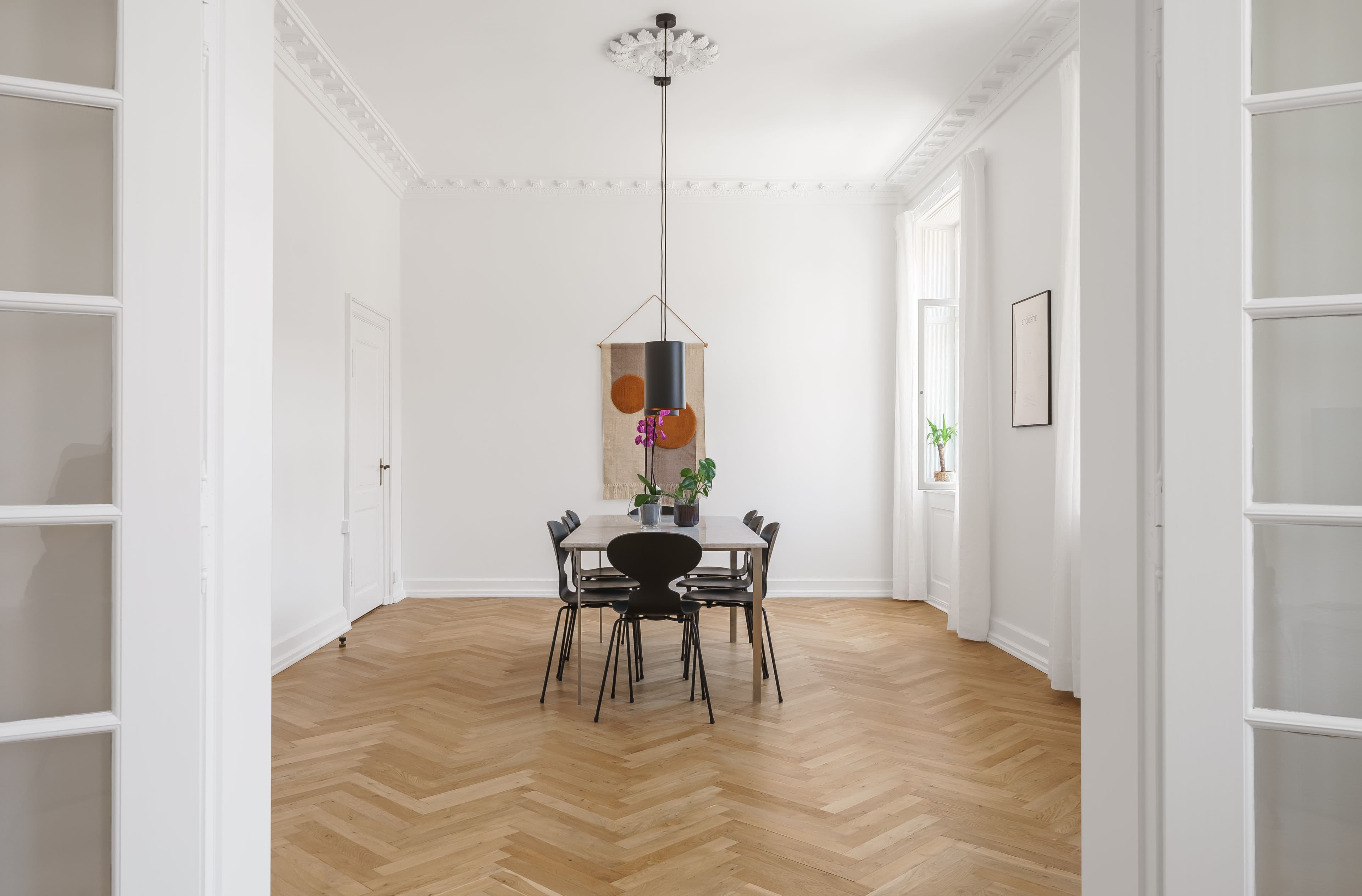 A diningroom with a big white dining table