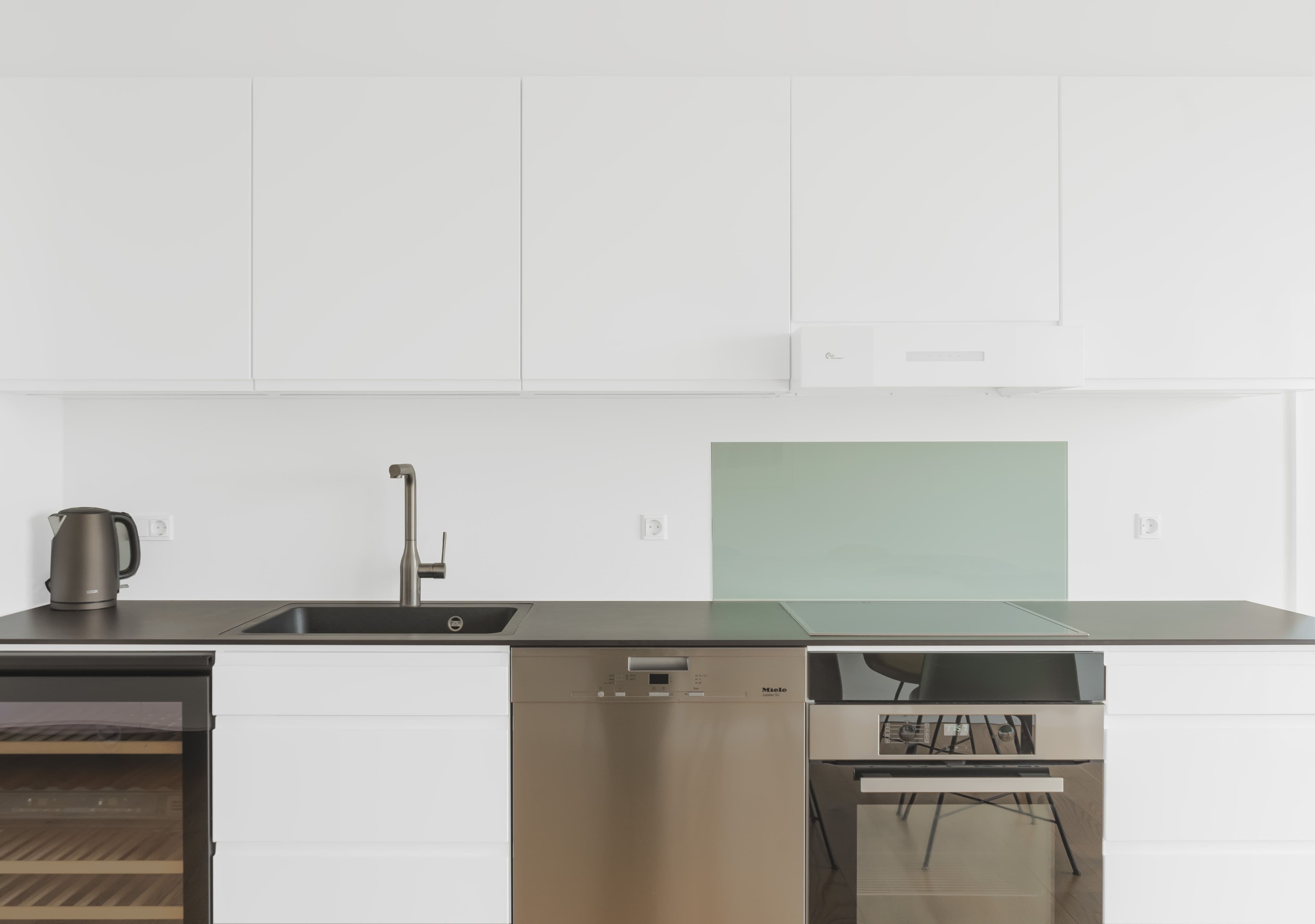 A kitchen with a black marble countertop