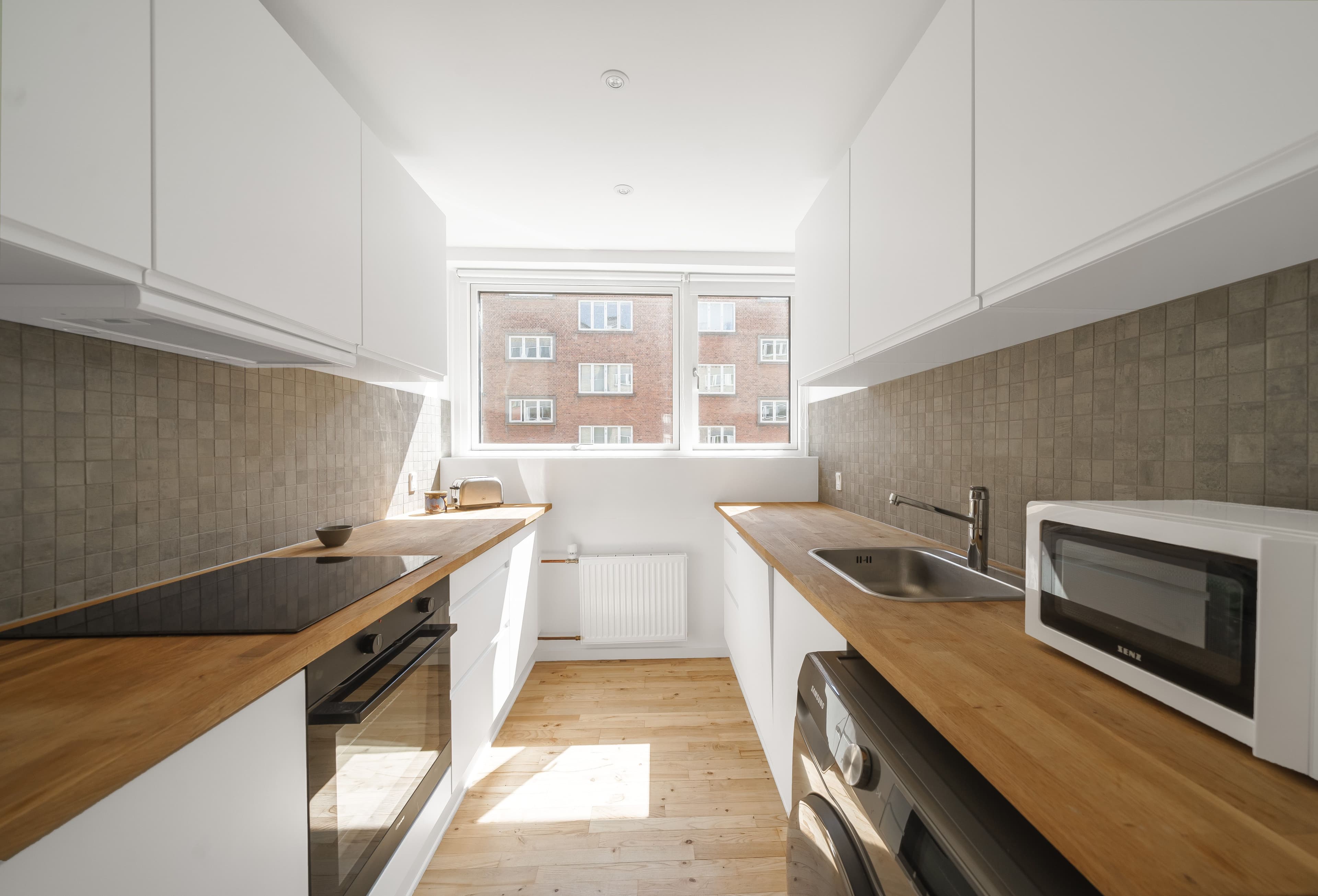 A modern kitchen with a wooden countertop