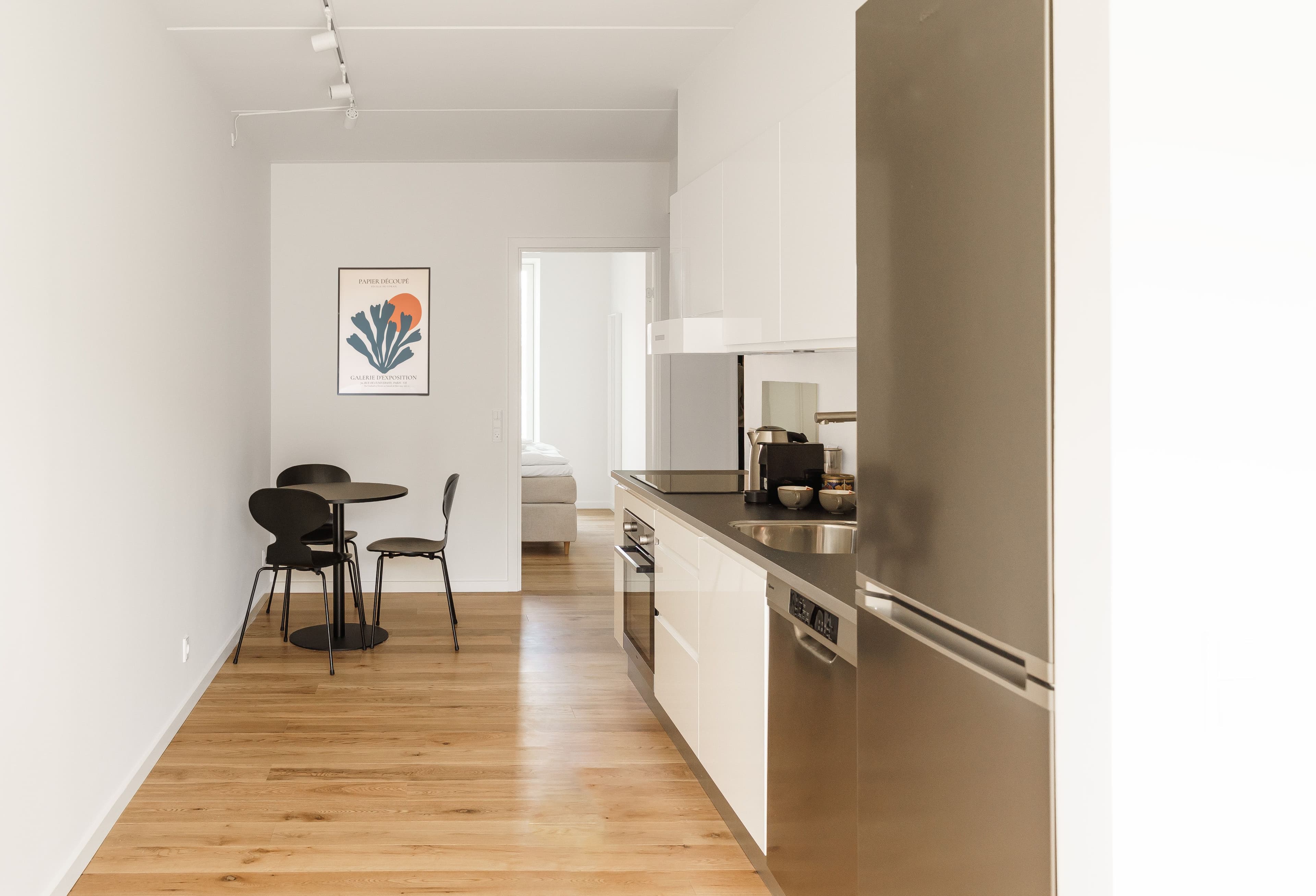 A livingroom with a modern kitchen